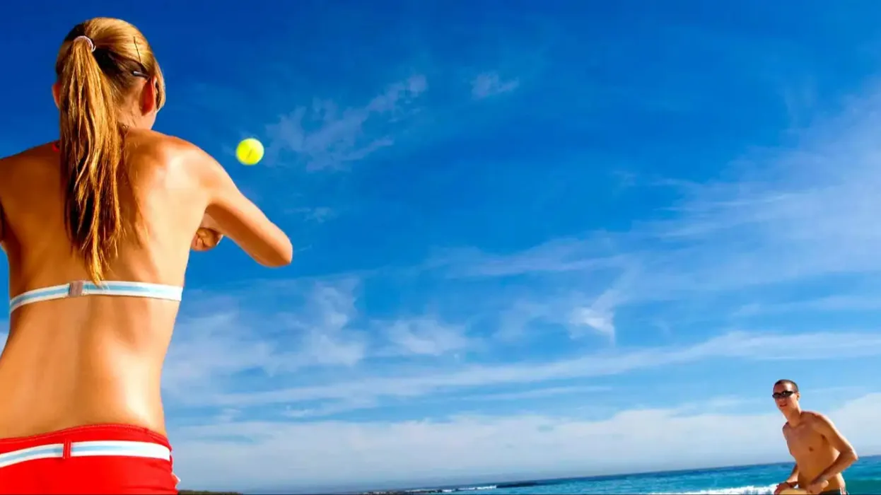 A couple playing beach paddle ball on Fujairah beach