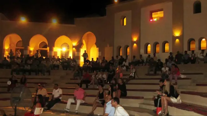 People sitting on Amphitheater at Miramar Al Aqah Beach Resort