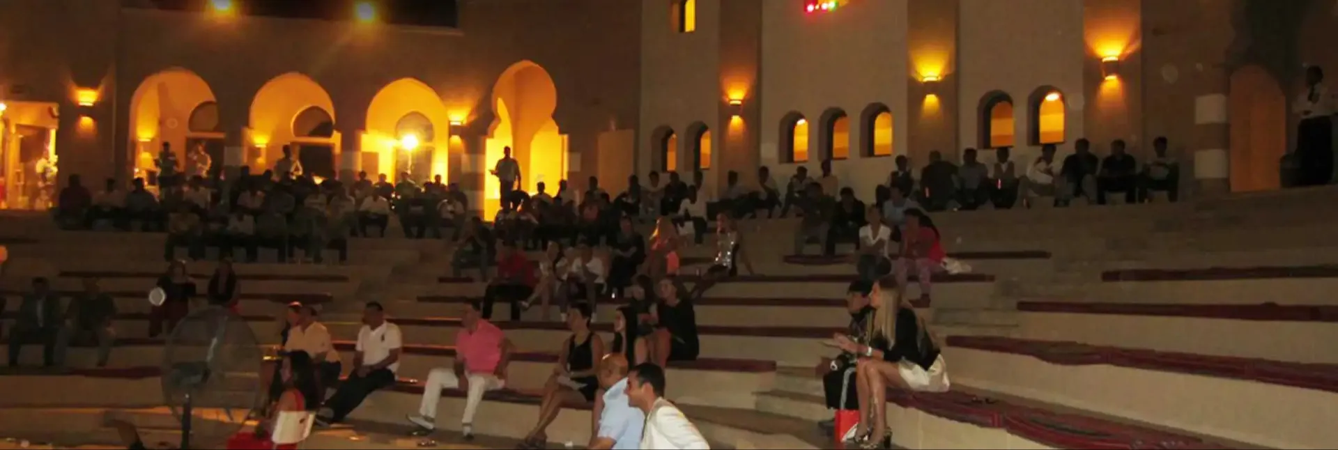 People sitting on Amphitheater at Miramar Al Aqah Beach Resort