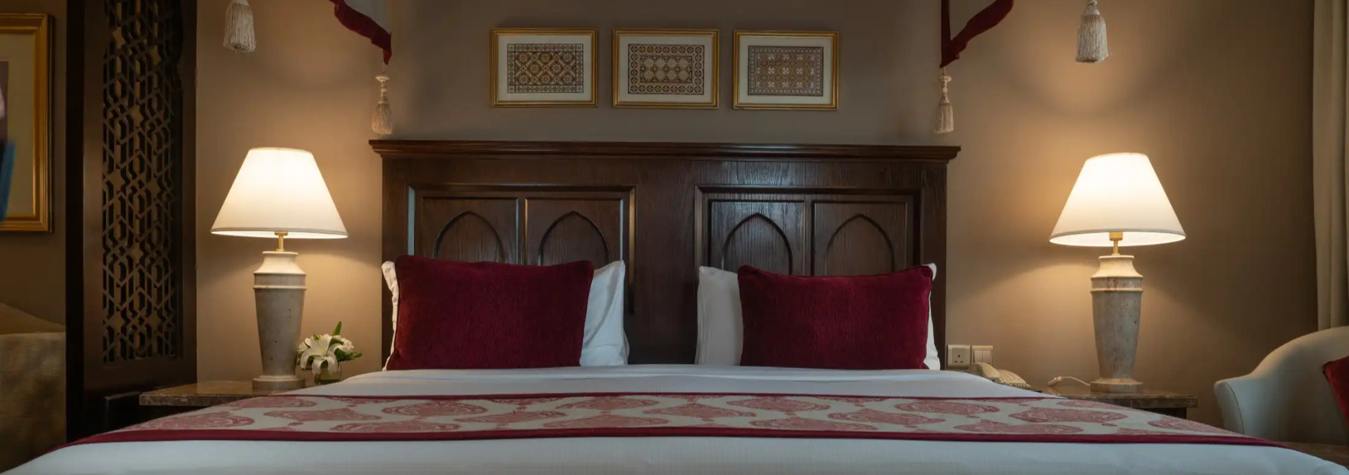 A queen size bed at the Al Dana Suite in Miramar Al Aqah Beach Resort
